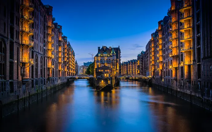 canal between buildings during nighttime